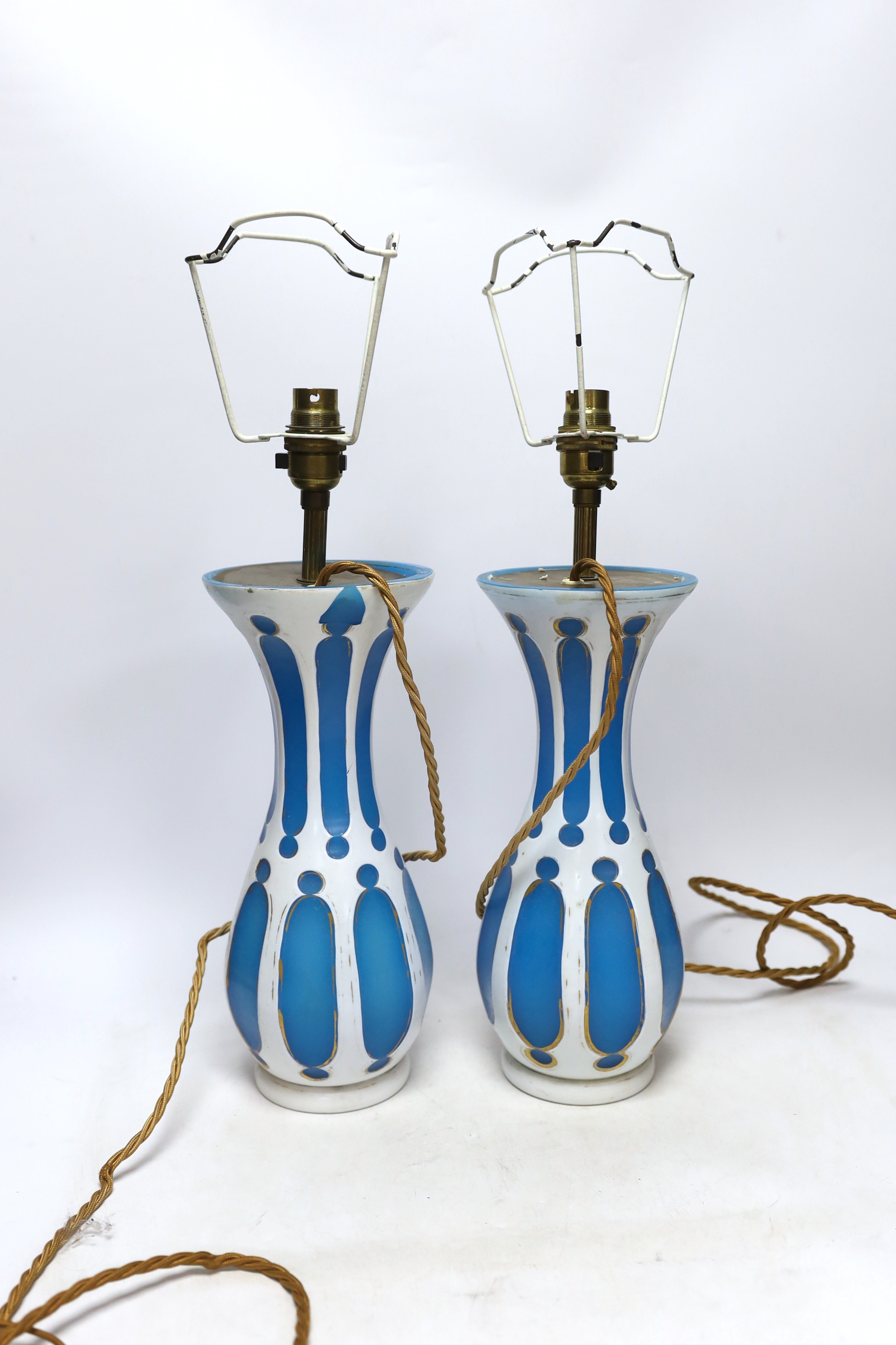 A pair of Bohemian overlaid glass vases, mounted as lamps